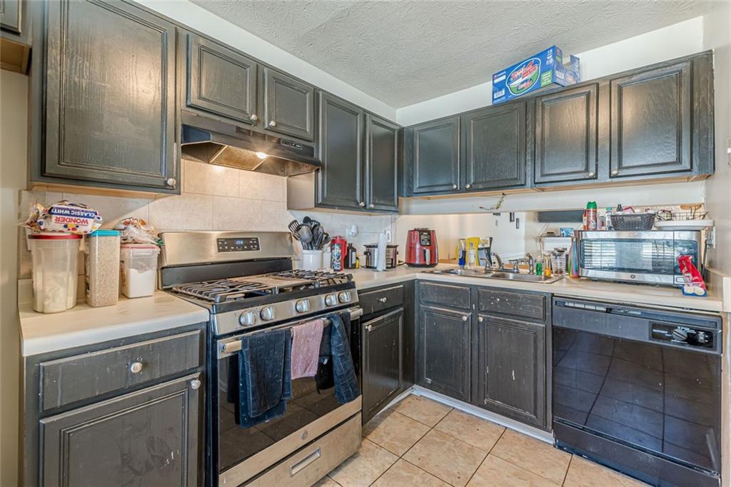 3477 Kingswood Trail Decatur, GA 30034 - Photo 3 of 44 a kitchen with stainless steel appliances granite countertop a stove and a sink