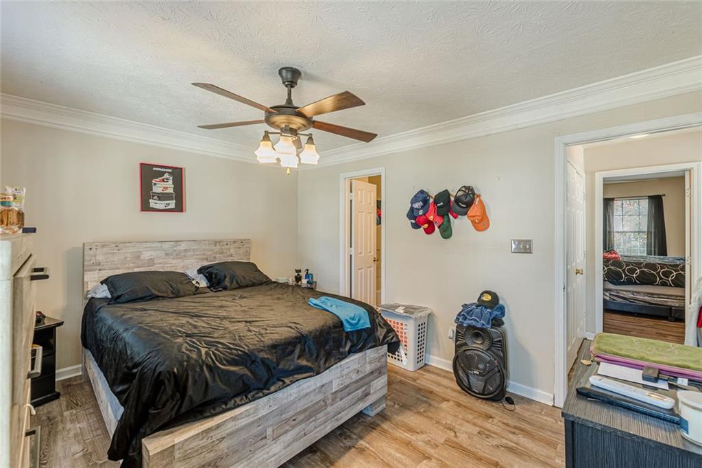 3477 Kingswood Trail Decatur, GA 30034 - Photo 40 of 44 a bedroom with a bed and a chandelier