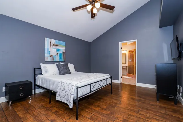 a bedroom with a bed and a chandelier