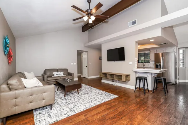 a living room with furniture and a flat screen tv