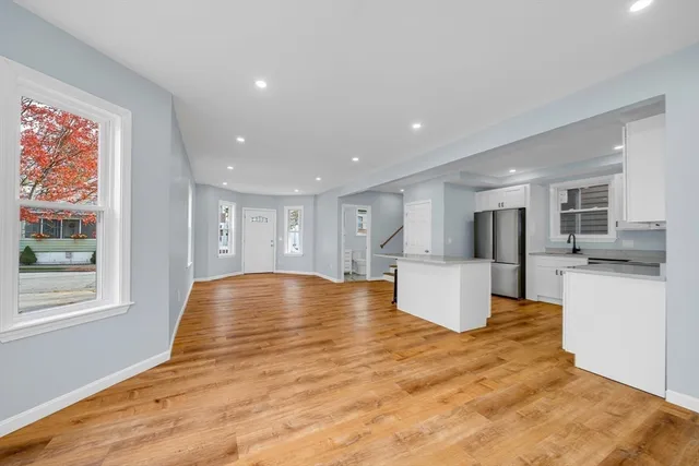 a view of kitchen with furniture and refrigerator