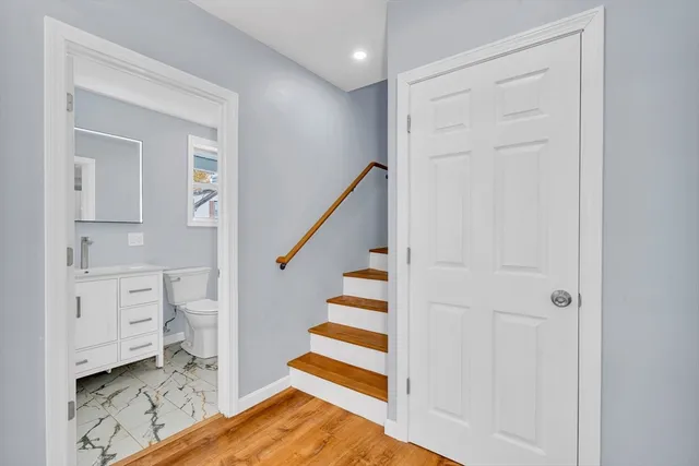 a view of entryway with wooden floor and stairs