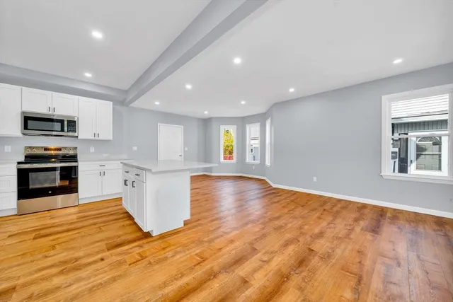 a view of kitchen with microwave and cabinets