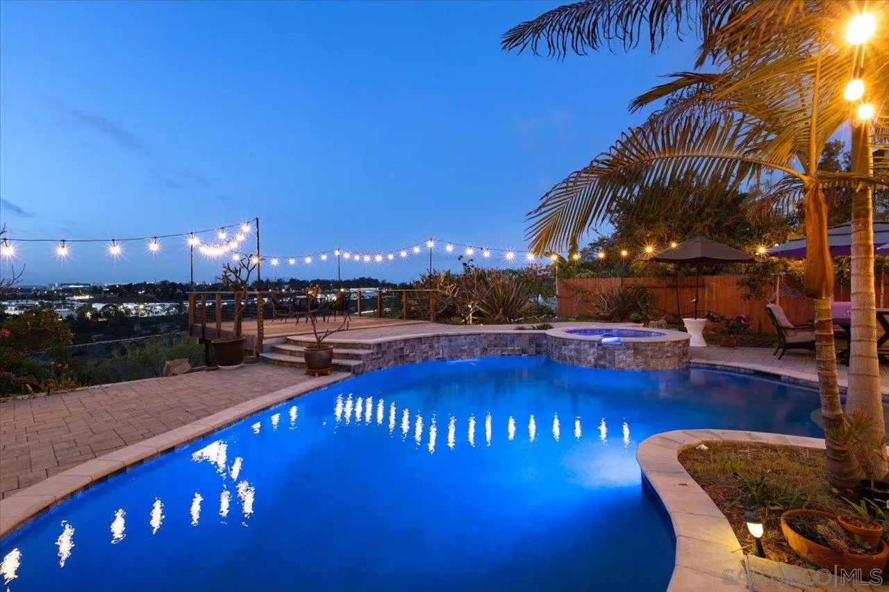 a view of swimming pool with outdoor seating and plants