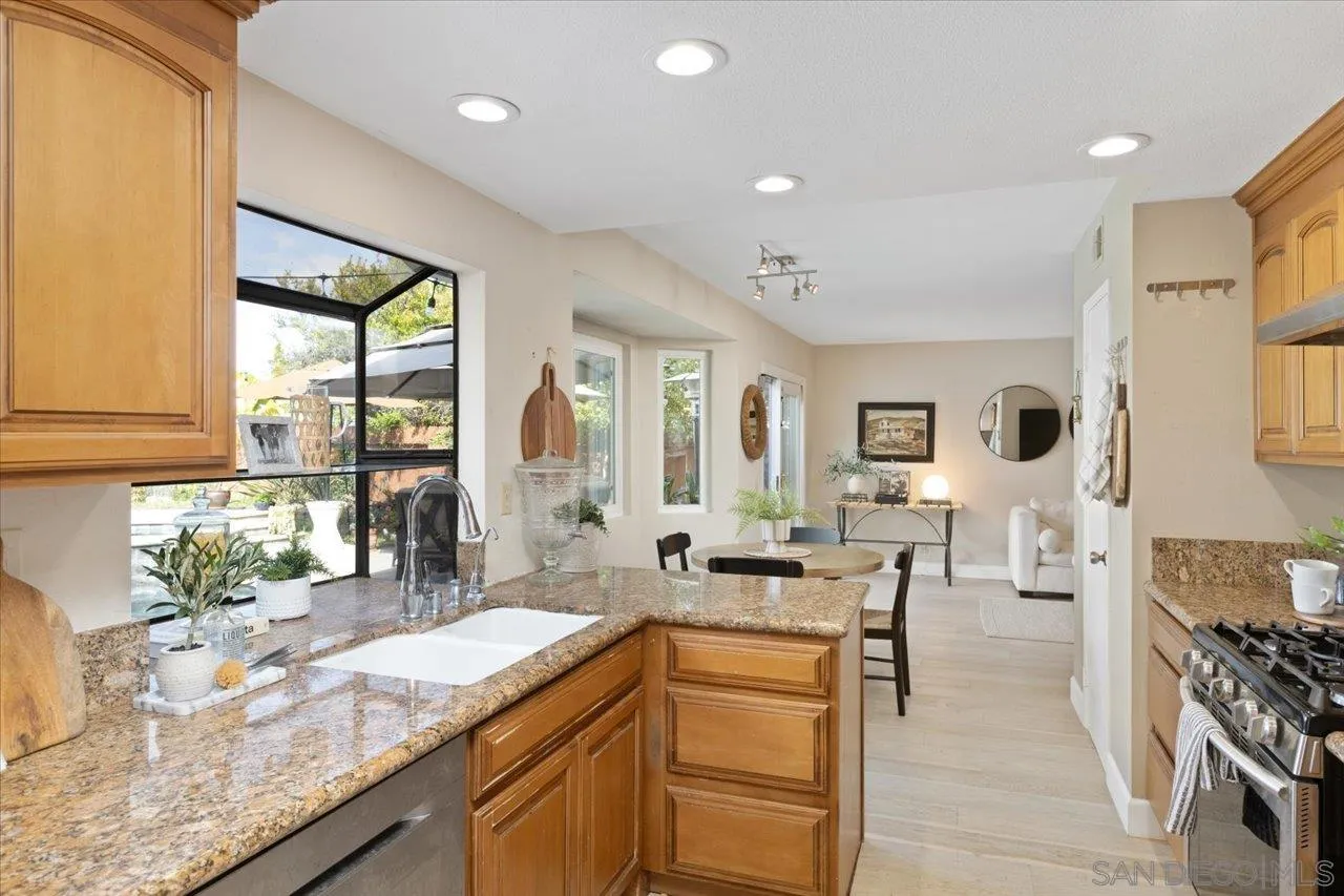3746 Kelton Drive Oceanside, CA 92056 - Photo 17 of 49 a kitchen with granite countertop a sink and counter top space