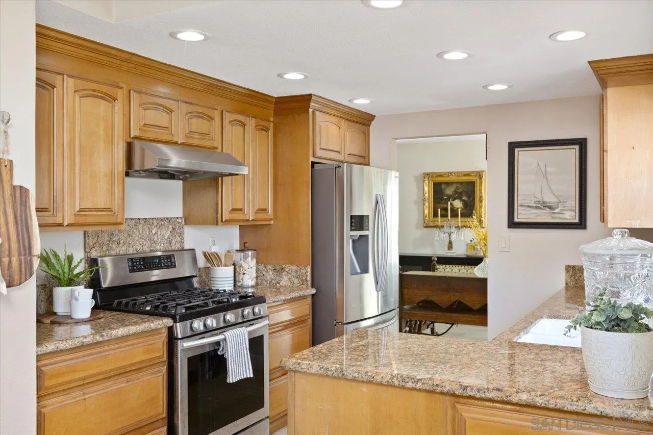 3746 Kelton Drive Oceanside, CA 92056 - Photo 18 of 49 a kitchen with stainless steel appliances granite countertop a stove a sink and a refrigerator