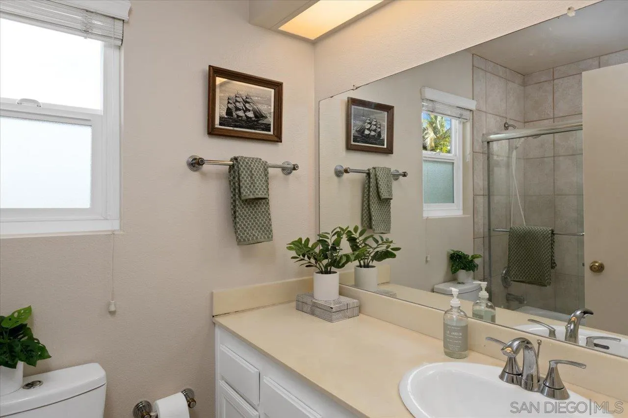 3746 Kelton Drive Oceanside, CA 92056 - Photo 28 of 49 a bathroom with a sink mirror and vanity
