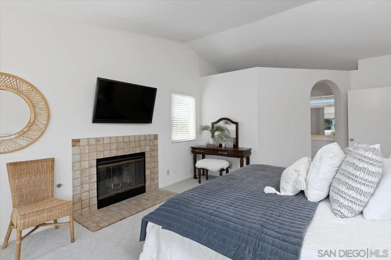 3746 Kelton Drive Oceanside, CA 92056 - Photo 36 of 49 a living room with furniture a fireplace and a flat screen tv