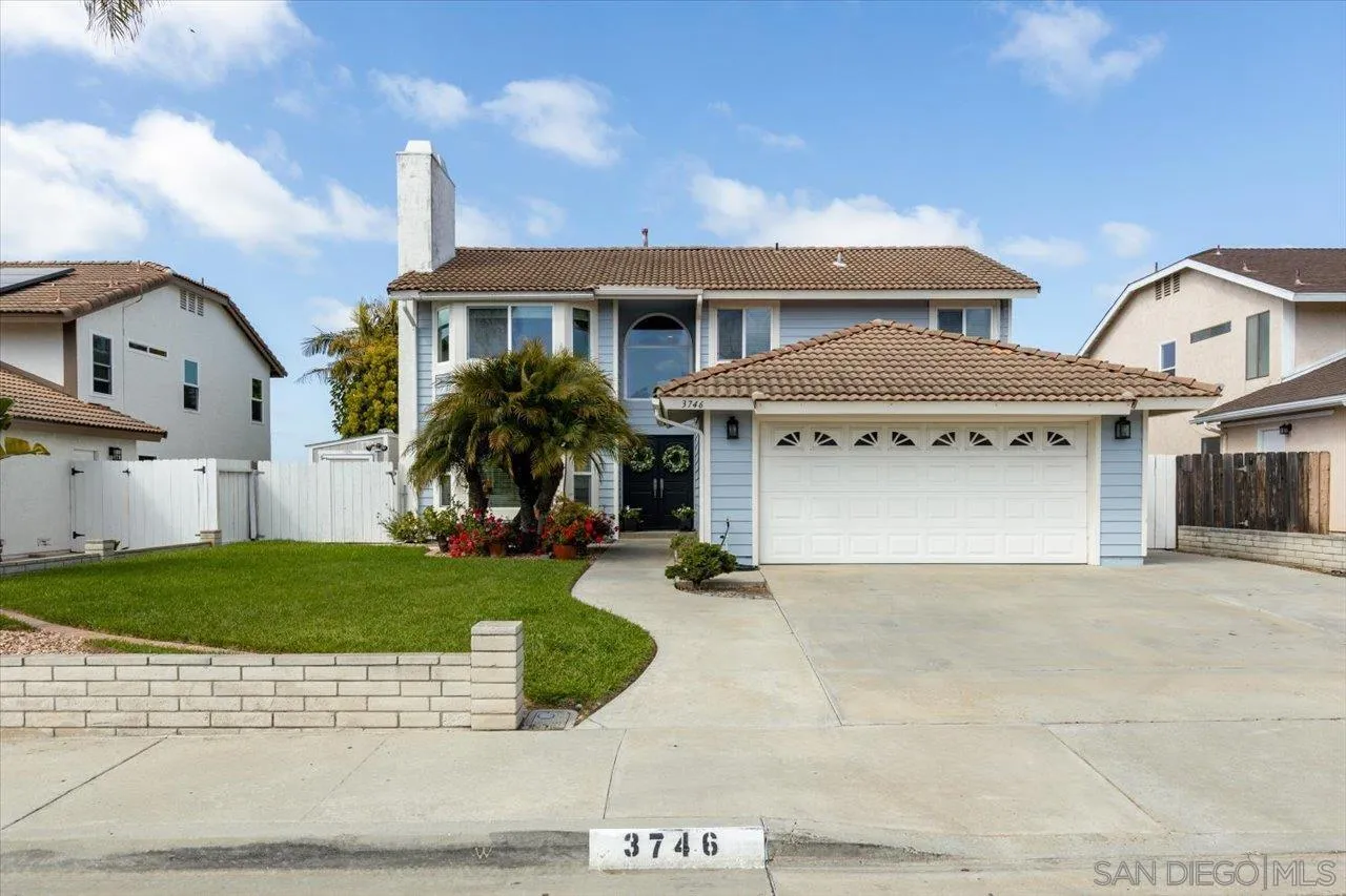 3746 Kelton Drive Oceanside, CA 92056 - Photo 40 of 49 a front view of a house with a yard and garage