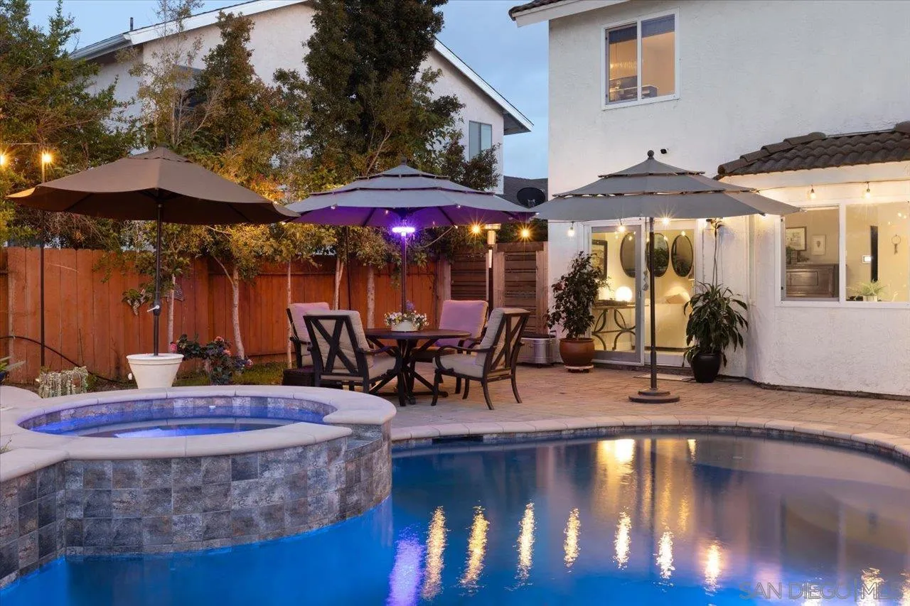 3746 Kelton Drive Oceanside, CA 92056 - Photo 7 of 49 a view of a patio with a table and chairs under an umbrella