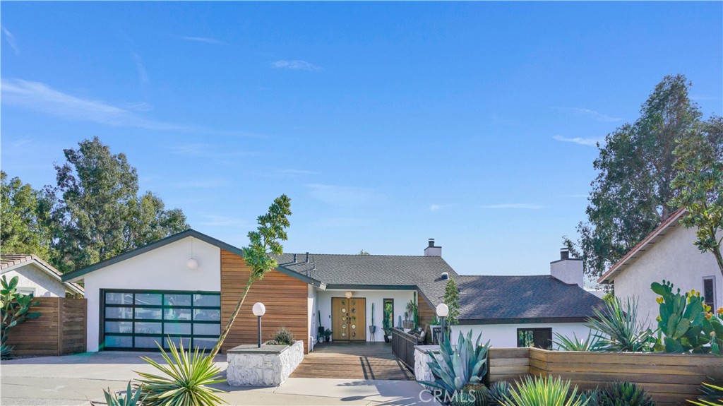 1574 East Dexter Street Covina, CA 91724 - Photo 1 of 56 a front view of a house with a garden
