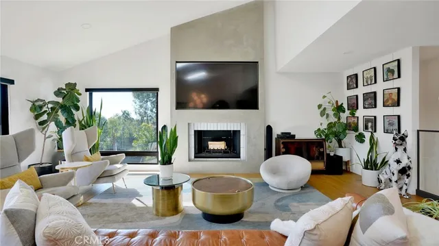 a living room with furniture fireplace and a flat screen tv