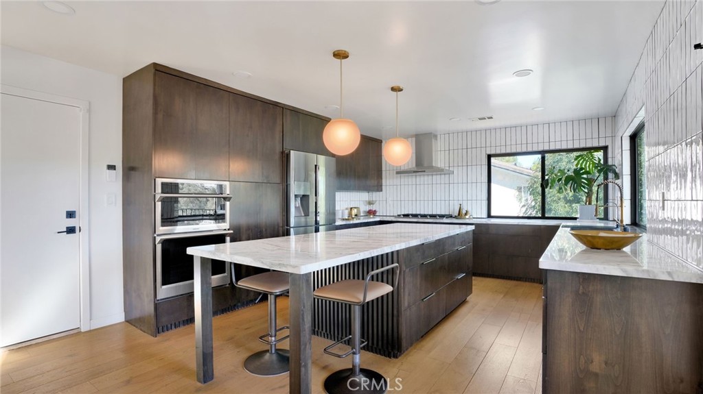 1574 East Dexter Street Covina, CA 91724 - Photo 20 of 56 a kitchen with stainless steel appliances granite countertop a sink a stove and a refrigerator