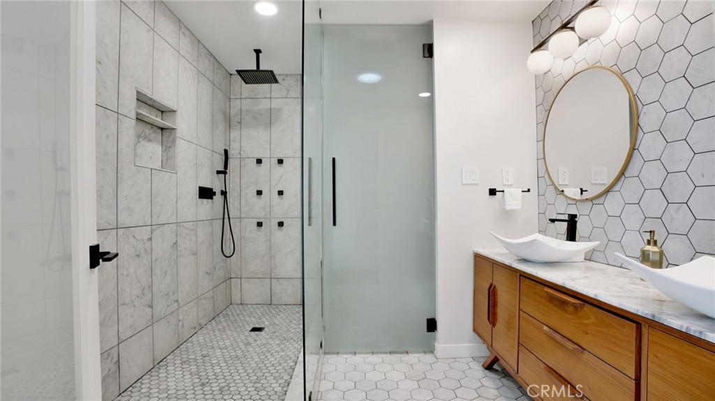 1574 East Dexter Street Covina, CA 91724 - Photo 26 of 56 a bathroom with a granite countertop sink a mirror and shower