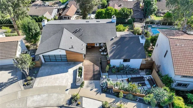 an aerial view of multiple houses with yard