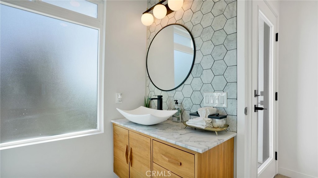 1574 East Dexter Street Covina, CA 91724 - Photo 45 of 56 a bathroom with a granite countertop sink a mirror and a shower