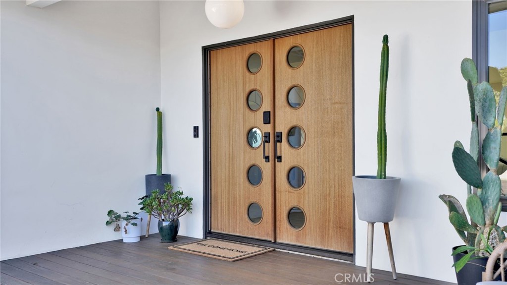 1574 East Dexter Street Covina, CA 91724 - Photo 8 of 56 a view of an entryway with potted plants