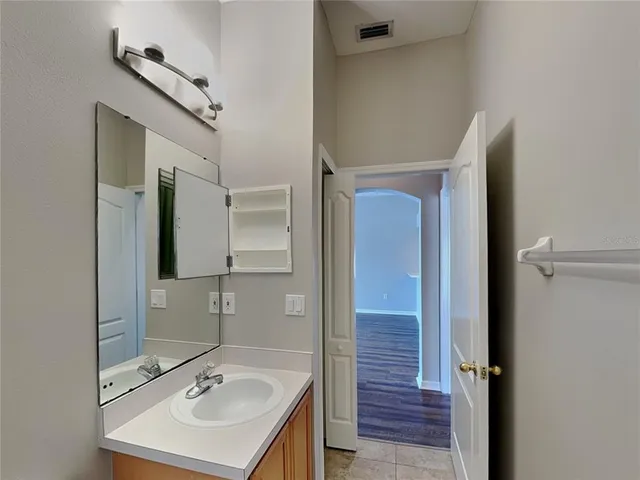 a bathroom with a sink mirror and shower