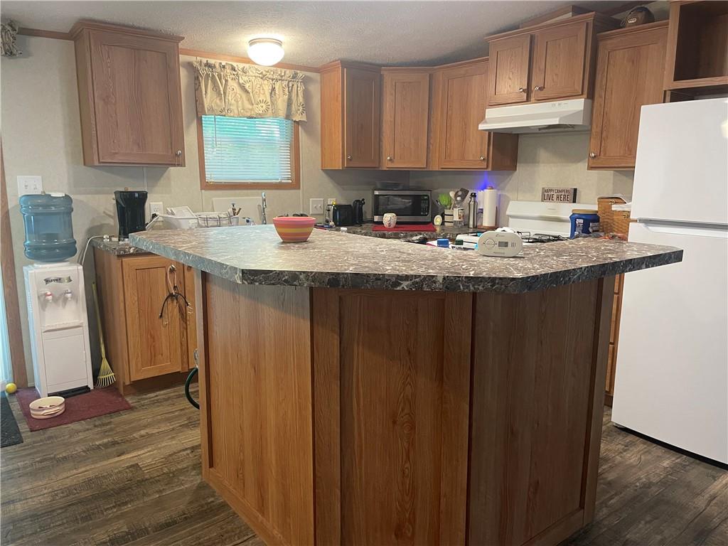 14624 Gilliland Road Linesville, PA 16424 - Photo 13 of 23 a kitchen with granite countertop a sink stove and cabinets