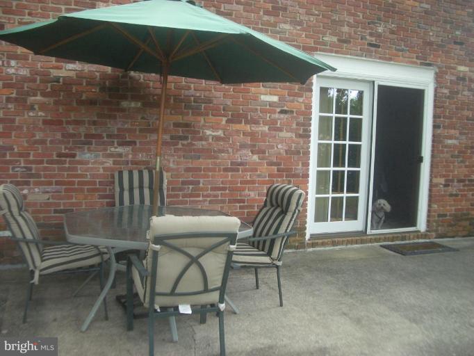 3624 Clifmar Road Windsor Mill, MD 21244 - Photo 14 of 17 a patio with table and chairs under an umbrella