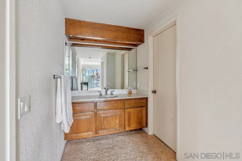 34 Montego Court Coronado, CA 92118 - Photo 23 of 31 a large bathroom with a double vanity sink and mirror