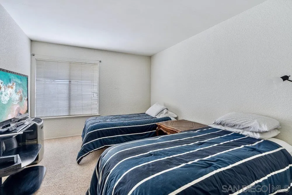 34 Montego Court Coronado, CA 92118 - Photo 26 of 31 a bedroom with a bed and a flat tv screen on a dresser