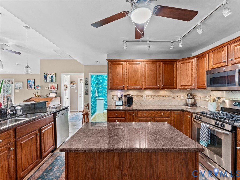 10488 Old Telegraph Road Ashland, VA 23005 - Photo 33 of 69 a kitchen with stainless steel appliances granite countertop a stove a sink dishwasher and a microwave oven with cabinets