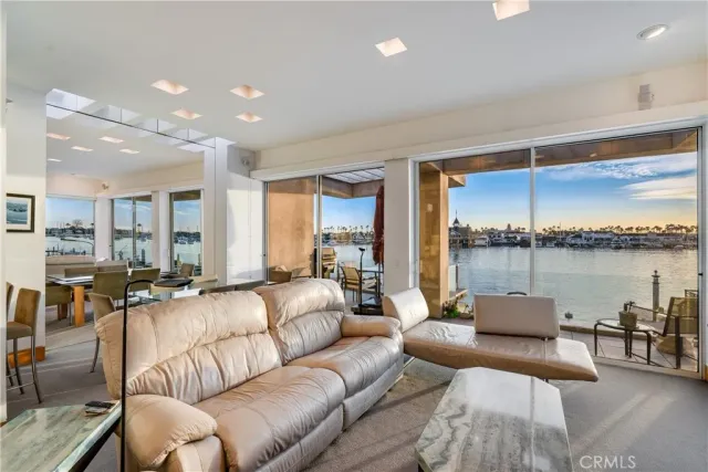 a living room with furniture kitchen and a potted plant