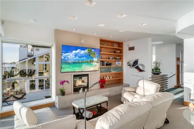 a living room with furniture and a floor to ceiling window