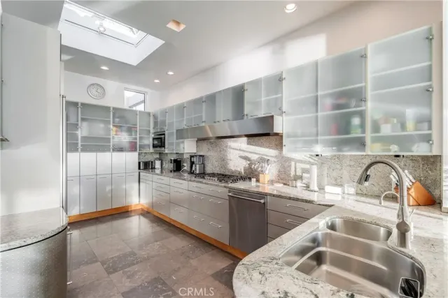 a kitchen with granite countertop a stove and a sink