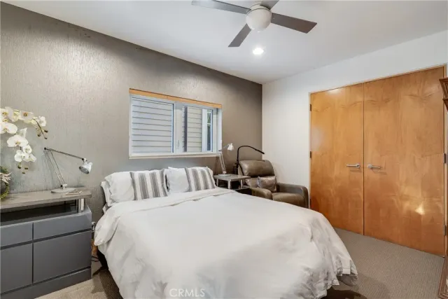 a bedroom with a bed and a painting on the wall