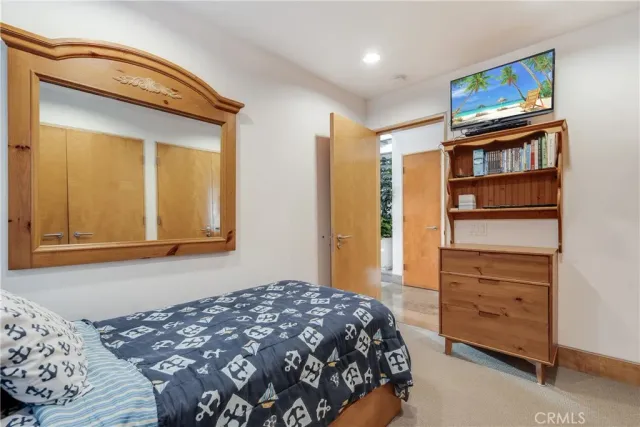 a living room with stainless steel appliances kitchen island granite countertop furniture and a rug
