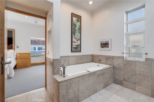 a bathroom with double vanity and a mirror