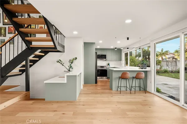 a kitchen with stainless steel appliances granite countertop a stove a sink a refrigerator and a refrigerator