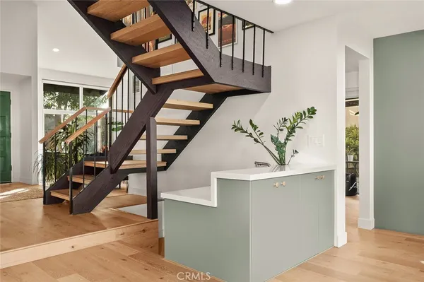 a kitchen with kitchen island a stove and a sink