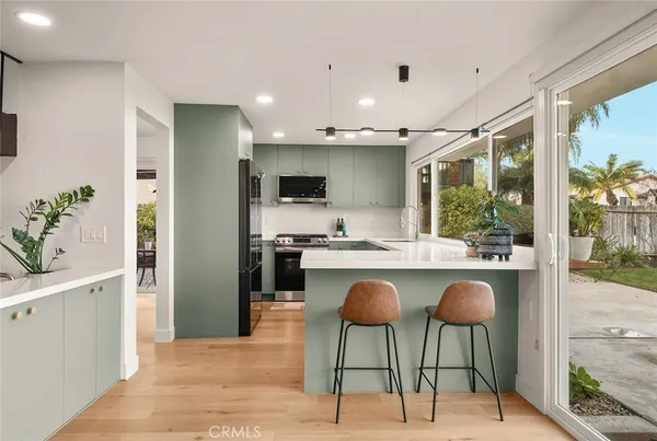 a kitchen with a sink stove and cabinets