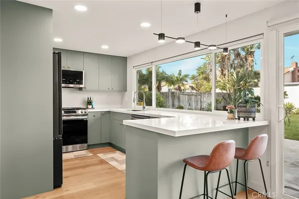 a large white kitchen with a large window