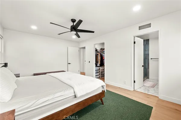 a bedroom with a large bed and a window