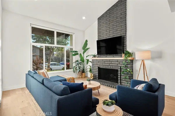 a living room with fireplace furniture and a flat screen tv