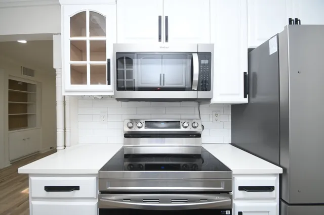 a kitchen with a refrigerator stove and microwave