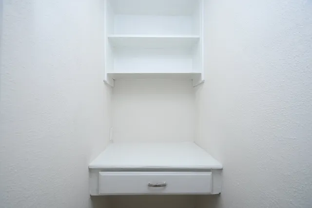 a bathroom with a bathtub shower sink mirror vanity and toilet