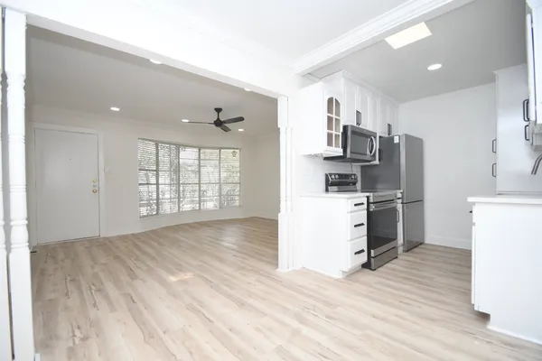 a kitchen with stainless steel appliances a refrigerator and a stove top oven