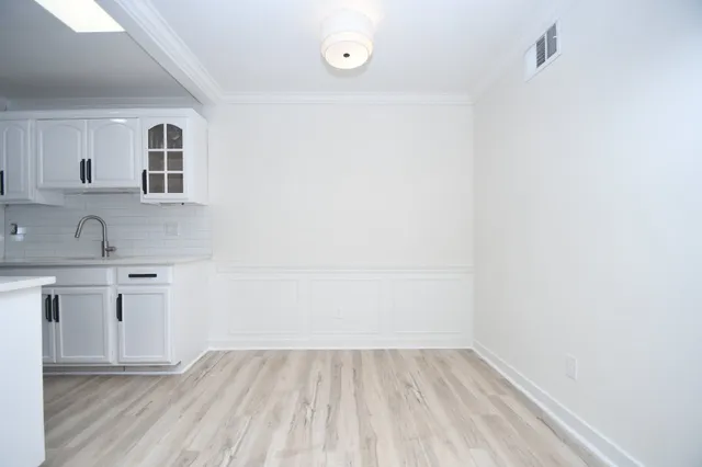 a view of a kitchen with wooden floor and a sink