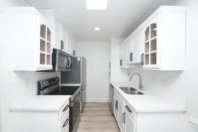 a kitchen with a sink and cabinets