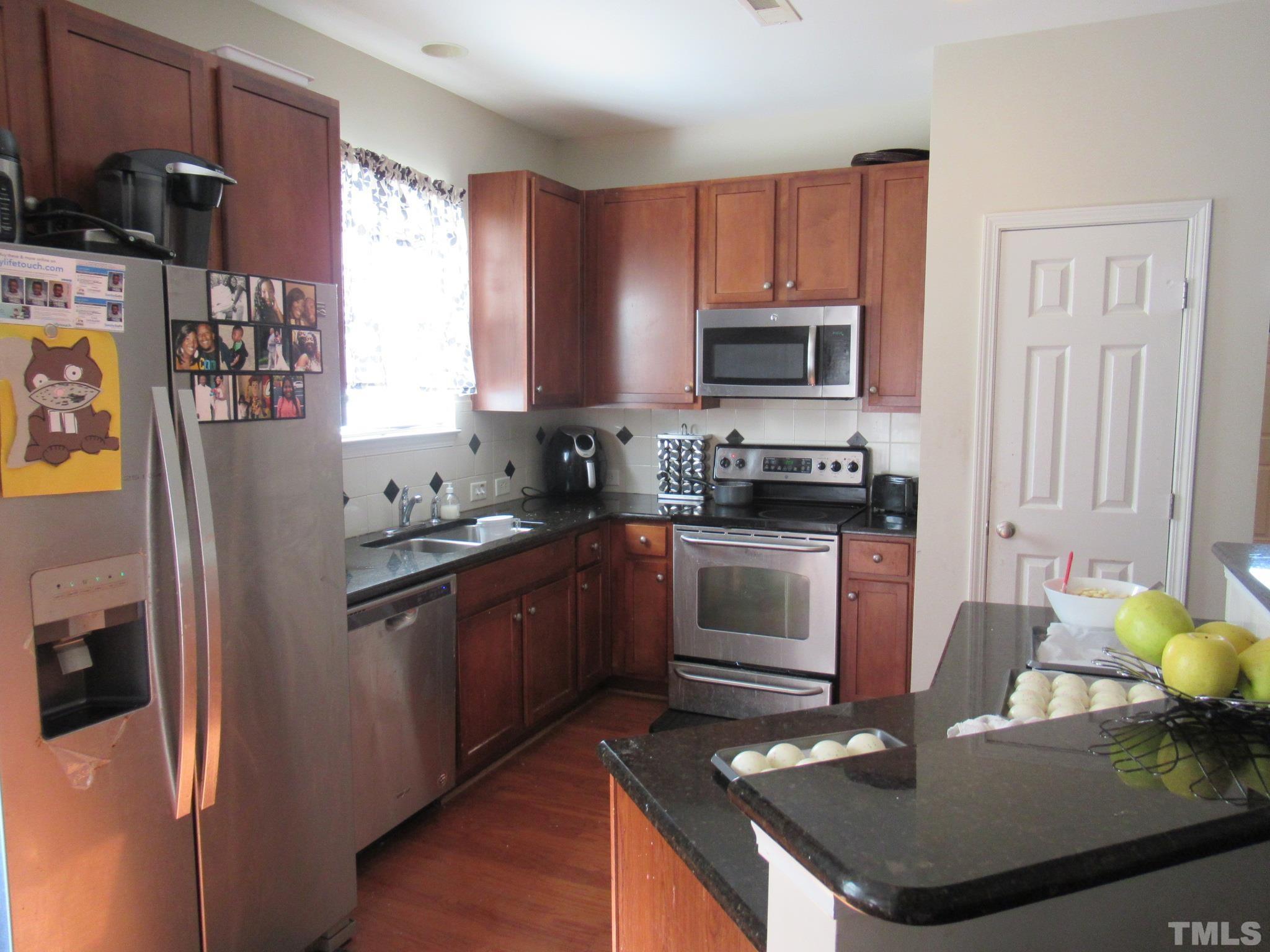 541 Ashgreen Court Rolesville, NC 27571 - Photo 4 of 15 a kitchen with stainless steel appliances granite countertop a stove refrigerator sink and microwave
