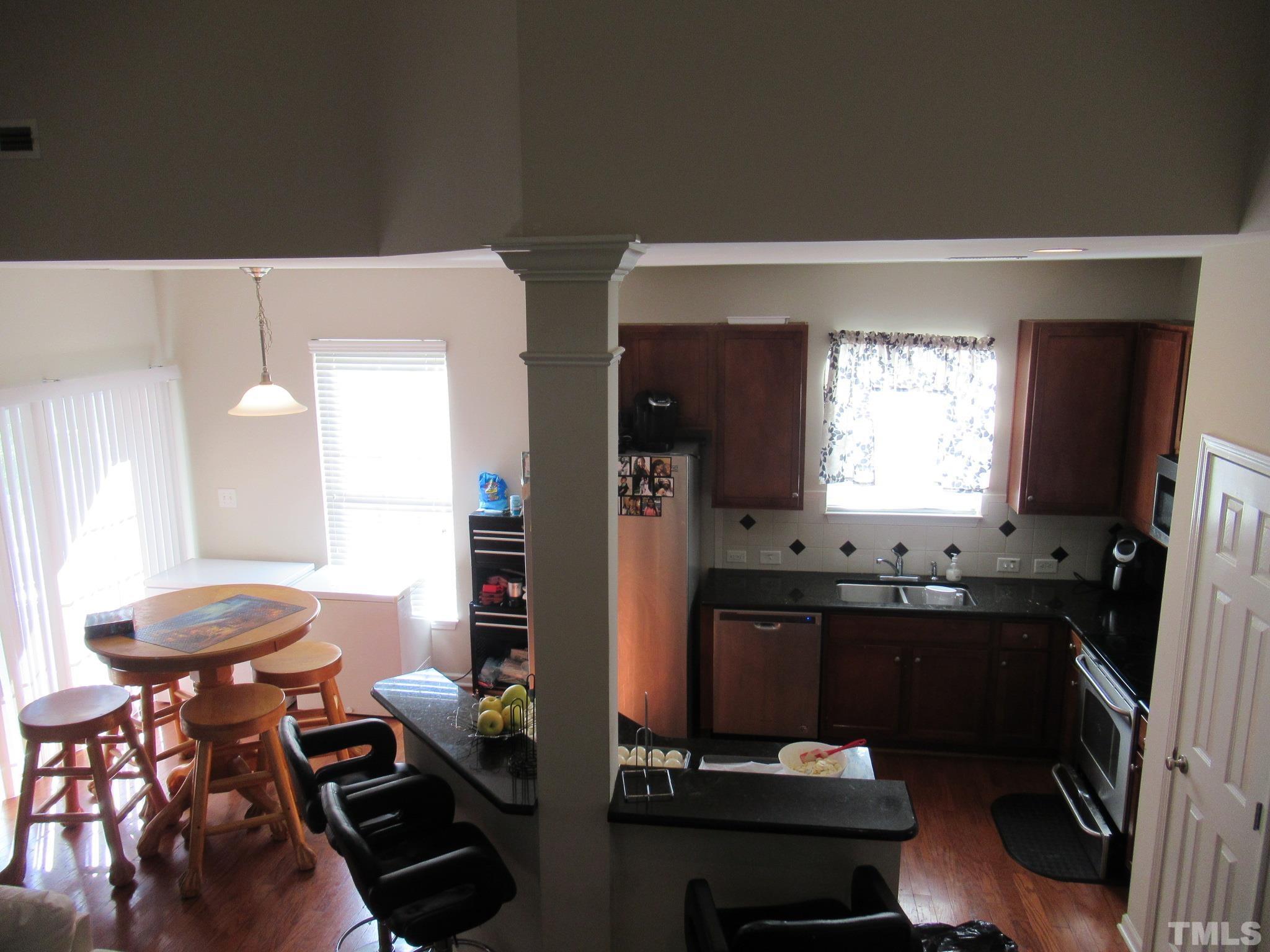 541 Ashgreen Court Rolesville, NC 27571 - Photo 6 of 15 a kitchen with sink refrigerator and dining table