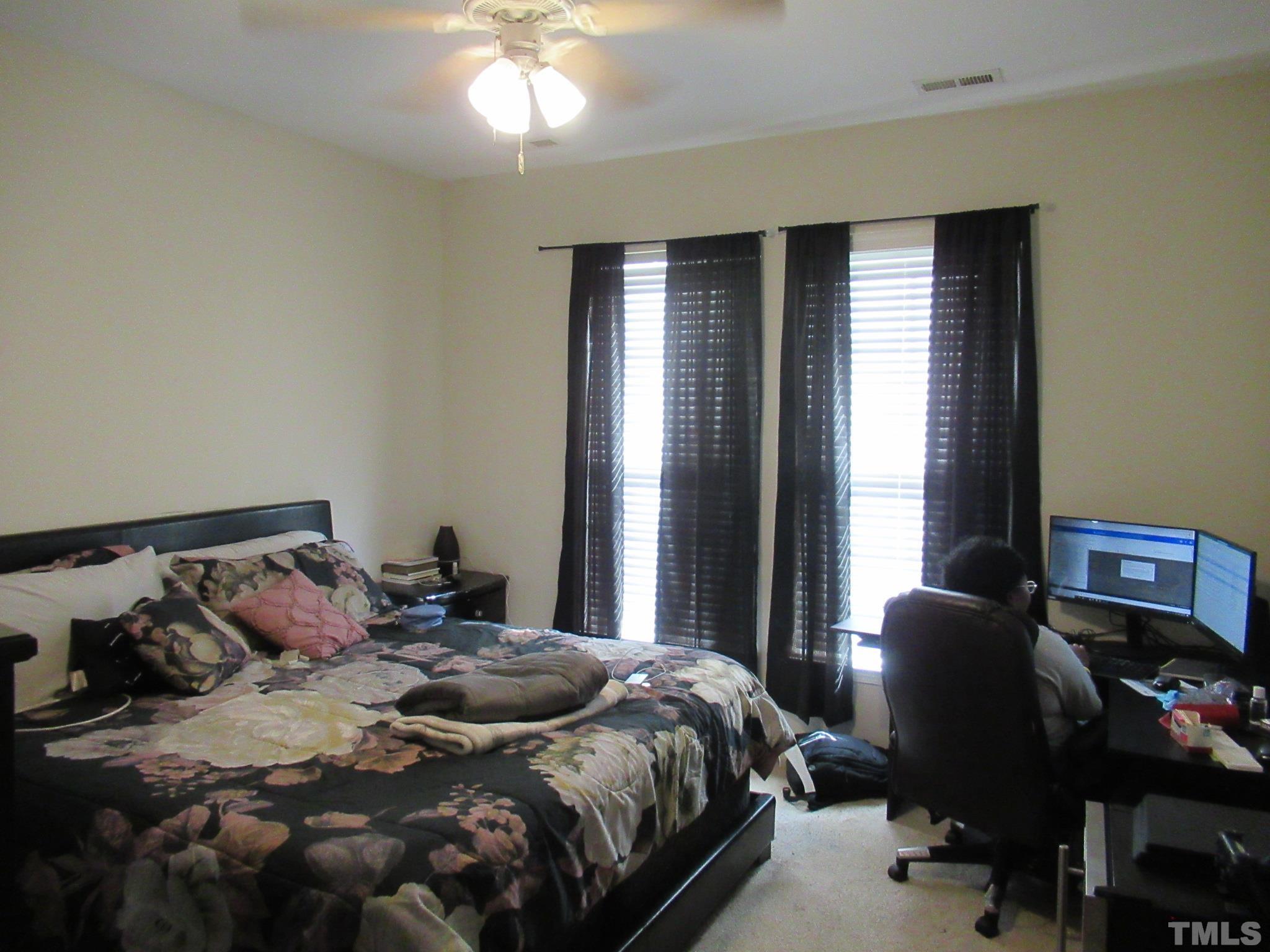 541 Ashgreen Court Rolesville, NC 27571 - Photo 8 of 15 a bedroom with a bed and windows