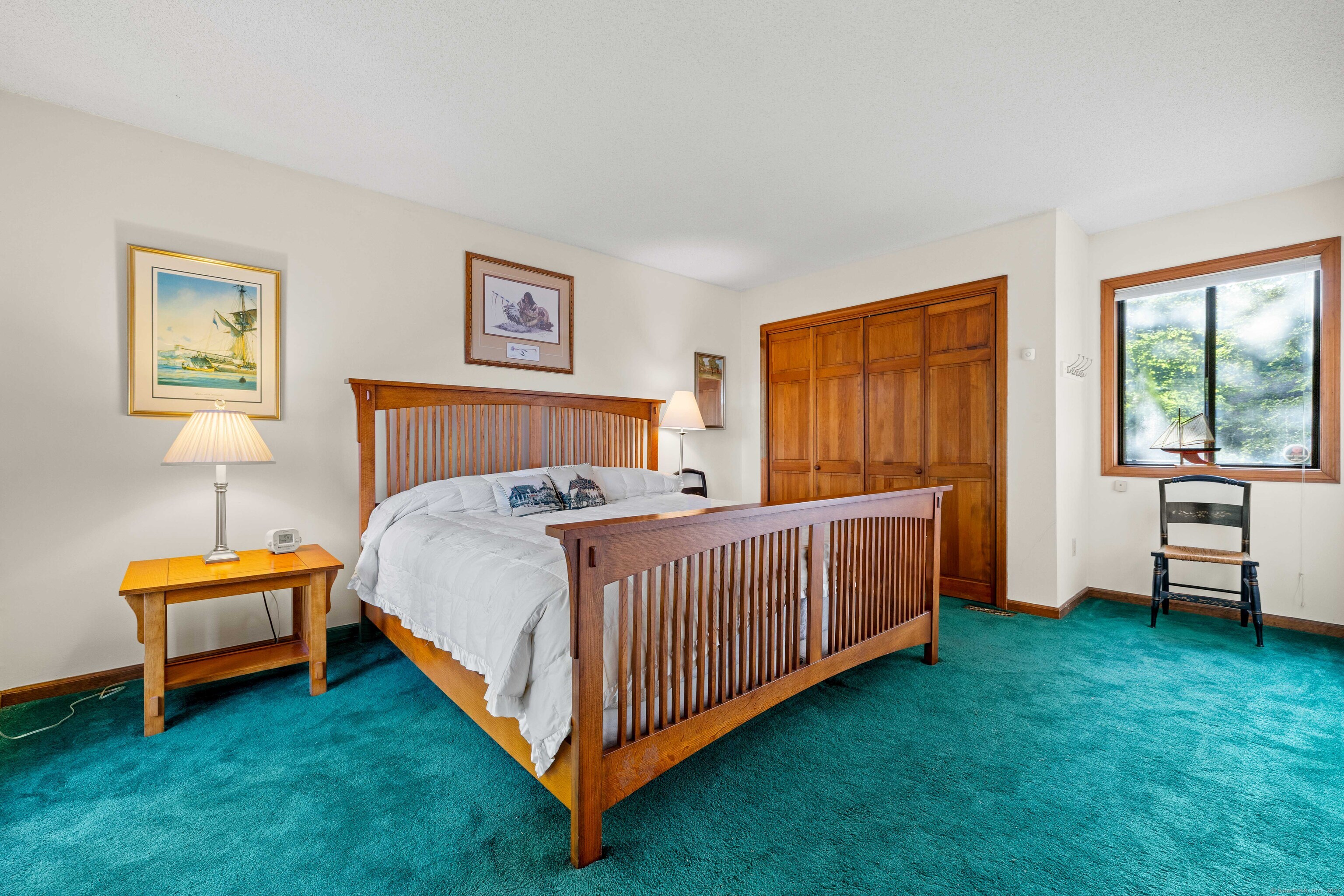 96 Ayers Point Road Old Saybrook, CT 06475 - Photo 22 of 39 a bed room with a bed and a chair