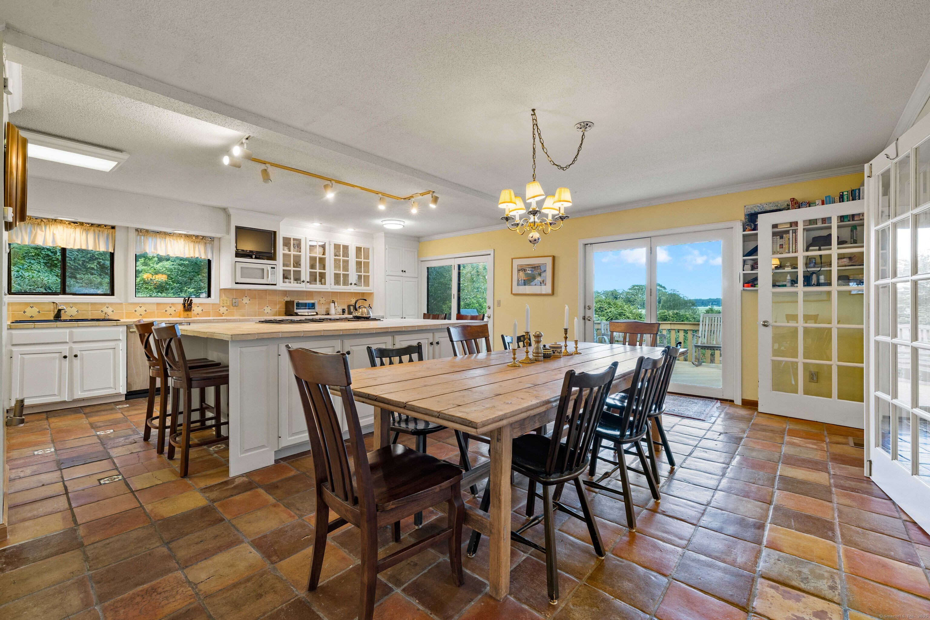 96 Ayers Point Road Old Saybrook, CT 06475 - Photo 8 of 39 a dining room with furniture a livingroom and chandelier