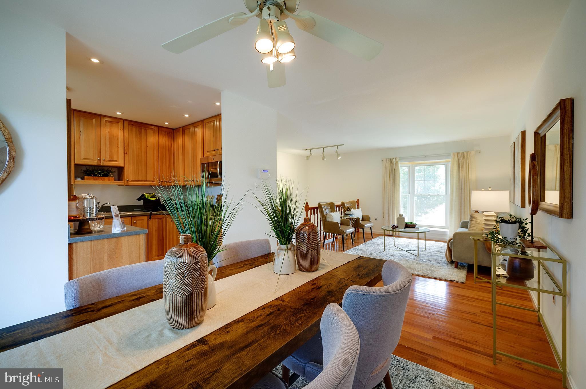 9212 Morley Road Lanham, MD 20706 - Photo 15 of 64 a view of a dining room with furniture a chandelier and wooden floor